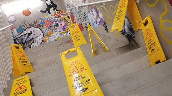 Several yellow wet floor warning signs