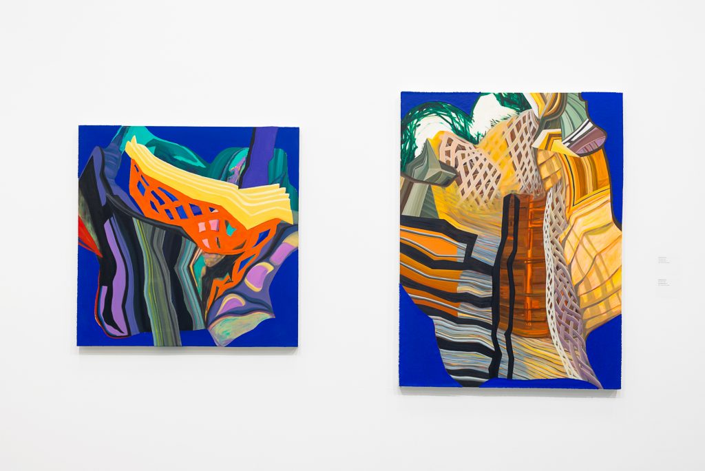 Two paintings of warped, striped buildings on a cobalt blue background. The left is a square canvas and shows an orange trellis and teal and purple colours; the right is a taller canvas and shows a brown trellis and has many shades of yellow and orange stripes. 