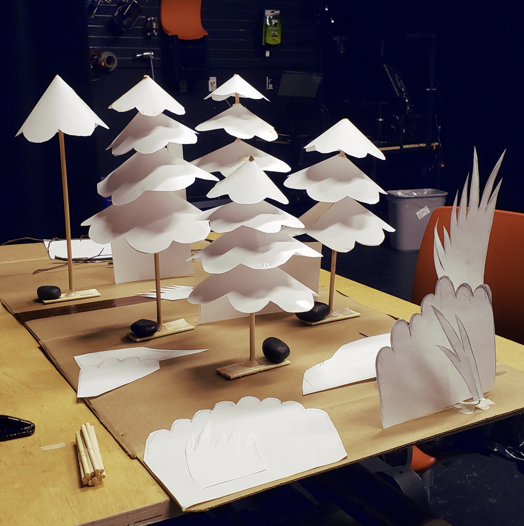 A paper and wood undecorated work in progress of the film's forest scenery stop motion set. There are five trees and various patches of paper bushes and grass.